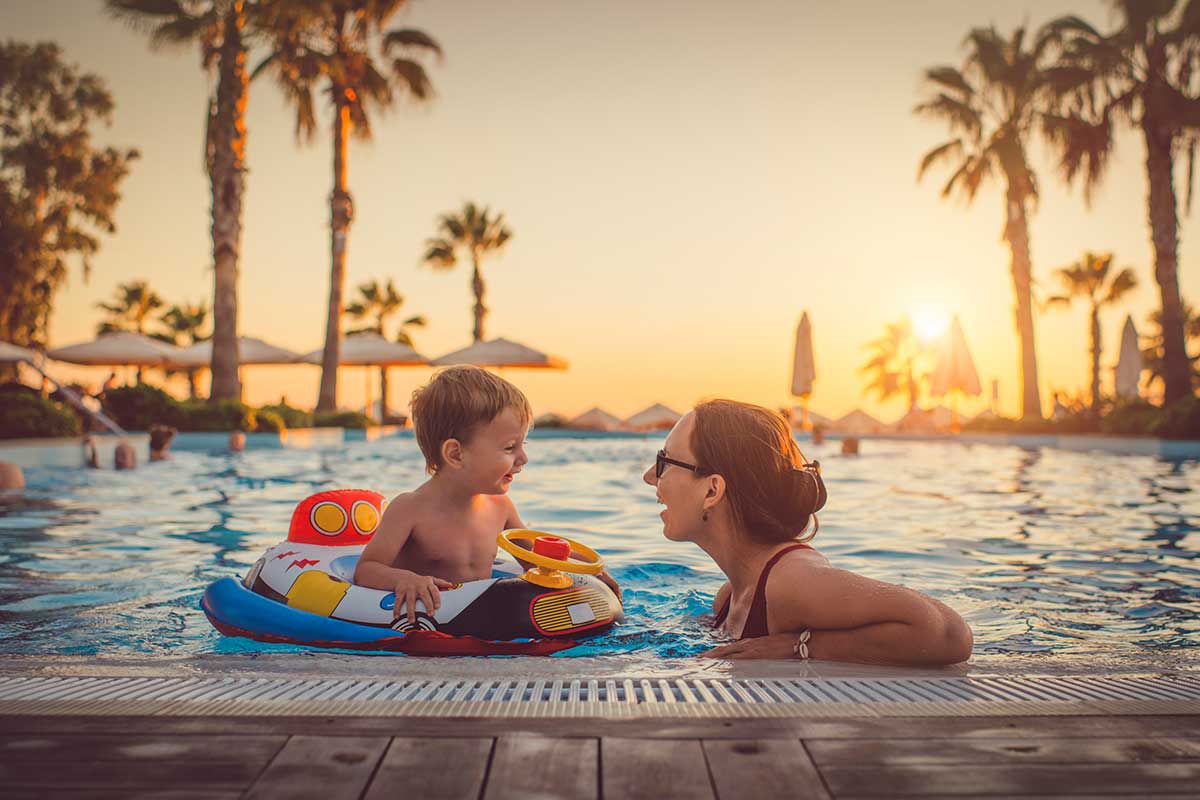 Australian family with young children enjoying a tropical resort pool